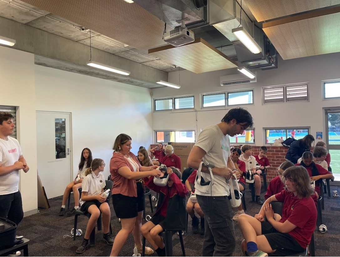 Year 8 English Teacher Ms Lucy Pellegrino assists 8A students with their new VR headsets